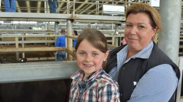 Ella Robertson, 7, was with CB Livestock and Property principal Colleen Bye, Rosedale. Ms Bye was selling about 110 head of cattle, on behalf of clients.