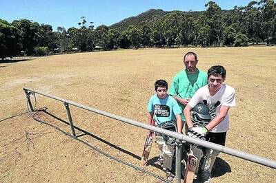 FAST OUTFIELD: Halls Gap residents Troy Hamilton and sons Hayden, 9, and Lachlan, 14, gear up for a hit on the outfield after locusts ate all the grass at the cricket ground. Pictures: PAUL CARRACHER