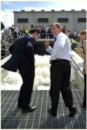 Premier John Brumby right and Water Minister Tim Holding look at the torrent of water flowing out of the Goulburn River into Sugarloaf reservoir via the North South pipeline. Picture: Craig Abraham The Age.