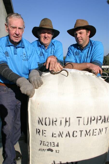 Three generations were loading the wool at North Tuppal and next week the wool will be sold. Cam Banks, 90, from Ballan, left, with his son-in-law Ian Smith, and his son David Smith, from Ballan, load a bale onto a dray during the re-enactment.