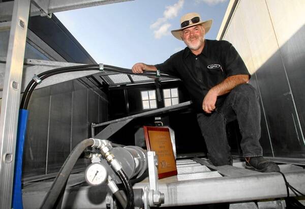 Warren Grose with the award-winning Fliegl Push Off Trailer System that acts as a grain bin, spreader or trailer.